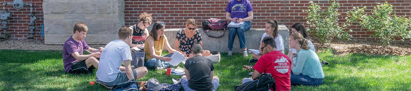 Students sitting outside for class.